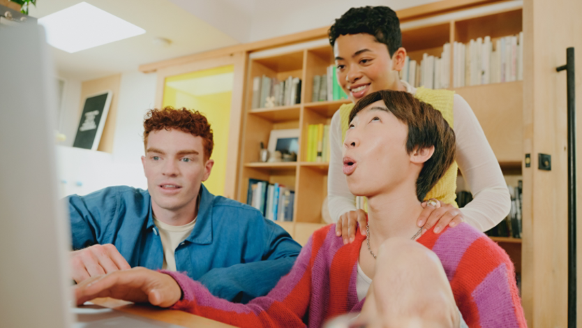 People laughing while looking at a Surface laptop