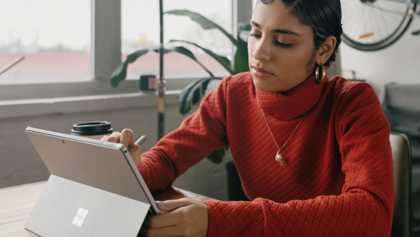 Person using Surface Pro 9 at their kitchen table