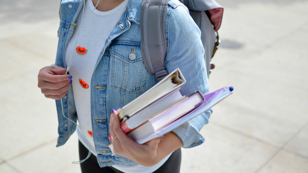 Student holding books on the way to class