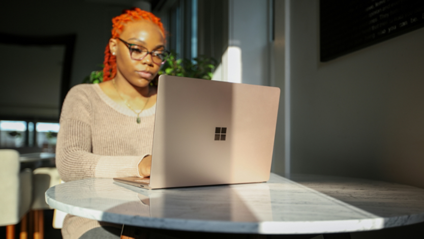 Woman typing on a Surface Laptop