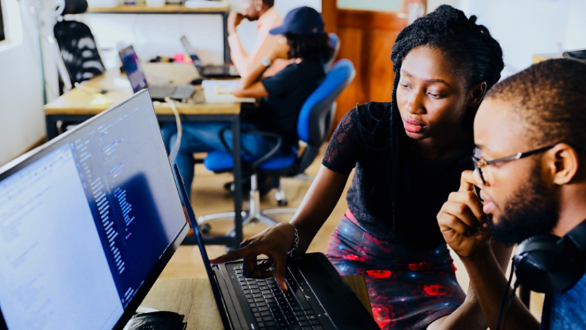 Woman and man working in front of a computer