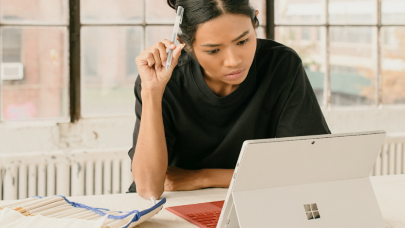 Woman looking at a surface device on a table