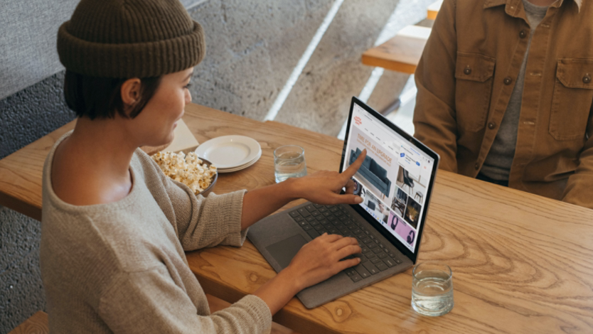 oman points to her laptop screen while online shopping