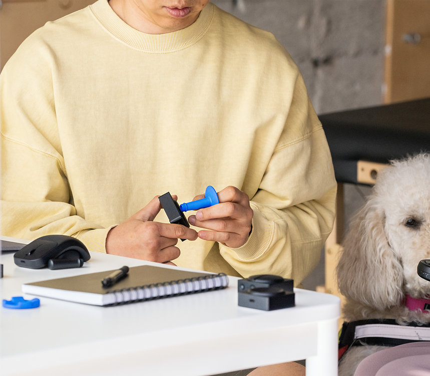 A person attaches a button topper to Microsoft adaptive accessories Button.