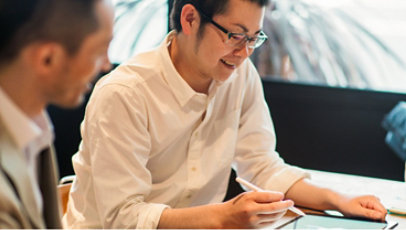 Two people sharing information using a tablet.