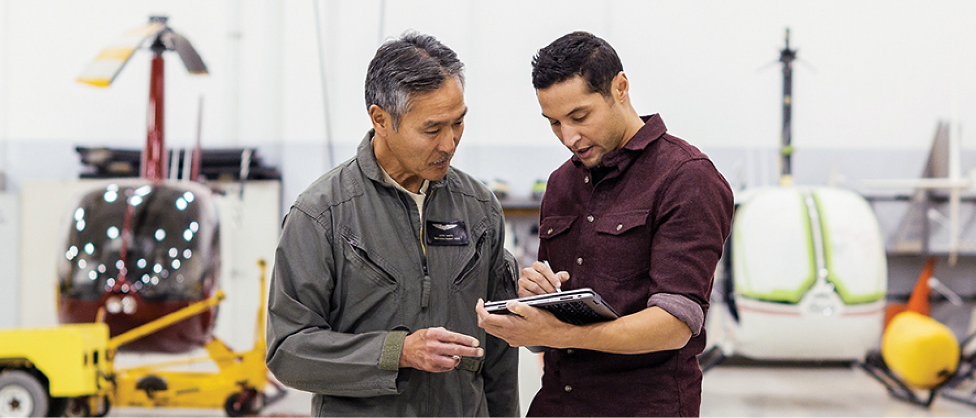 Two people in a warehouse working on a tablet