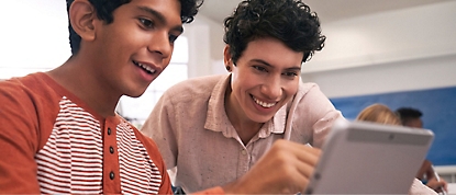 Two students are looking at a tablet.