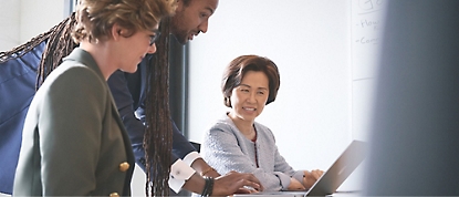 A group of people working together on a laptop.