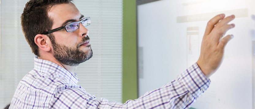 A person working with a big touch screen