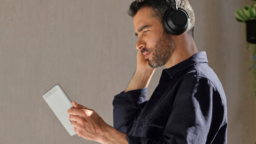 A person uses their Surface Go 4 and Surface Headphones 2+ to join a Teams meeting