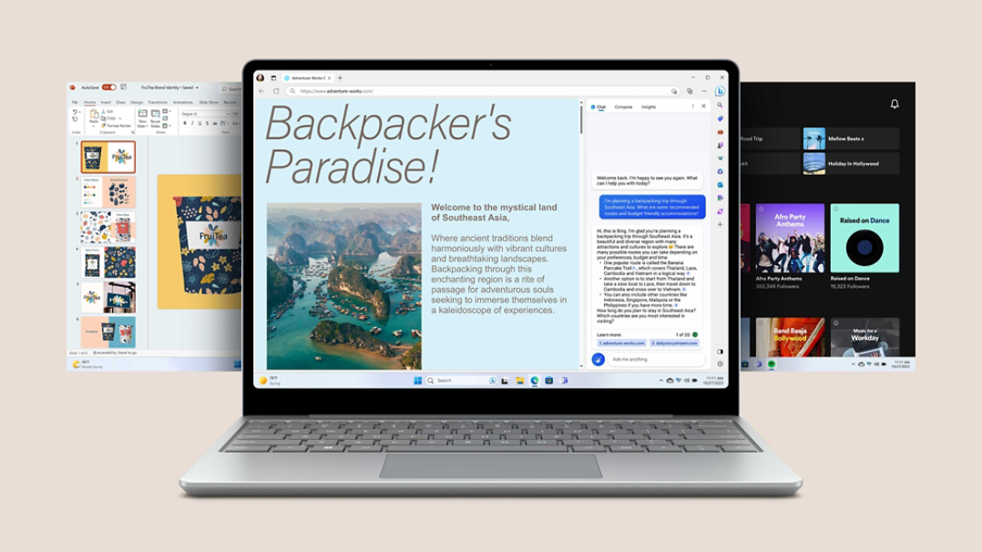 Surface Laptop Go 3 platinum menunjukkan Bing Edge pada skrin dengan dua skrin aplikasi lain mengintai dari belakang peranti.