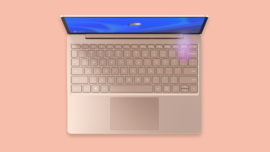 キーボードの右上隅で指紋リーダーが点灯する、サンドストーンの Surface Laptop Go 3 を上から見た画像。