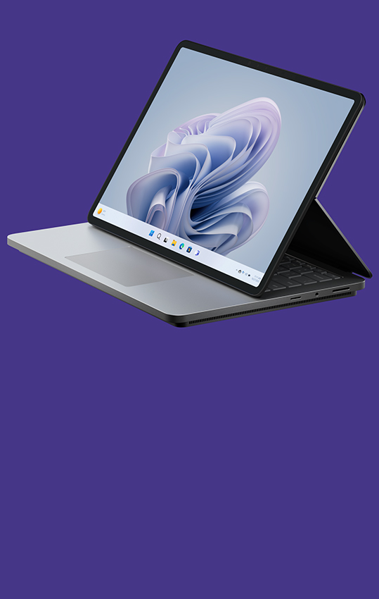 Ángulo lateral de Surface Laptop Studio 2 que muestra una flor de Windows en la pantalla.