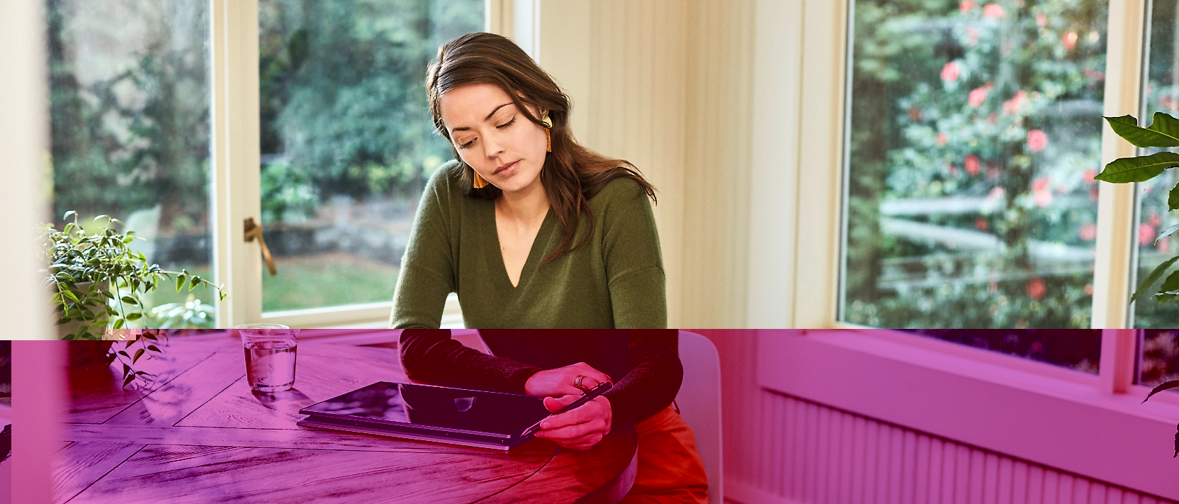 A woman sitting at a table with a tablet computer.