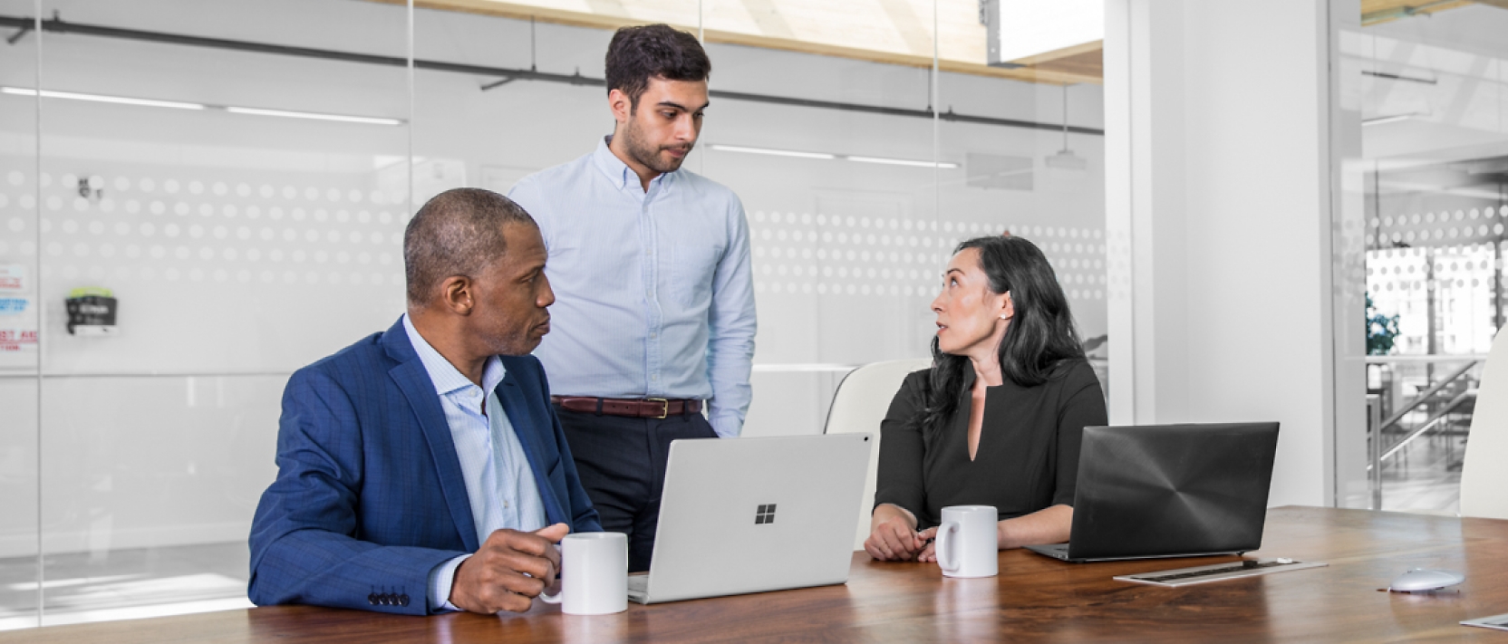 A group of people sitting around a table in an office.