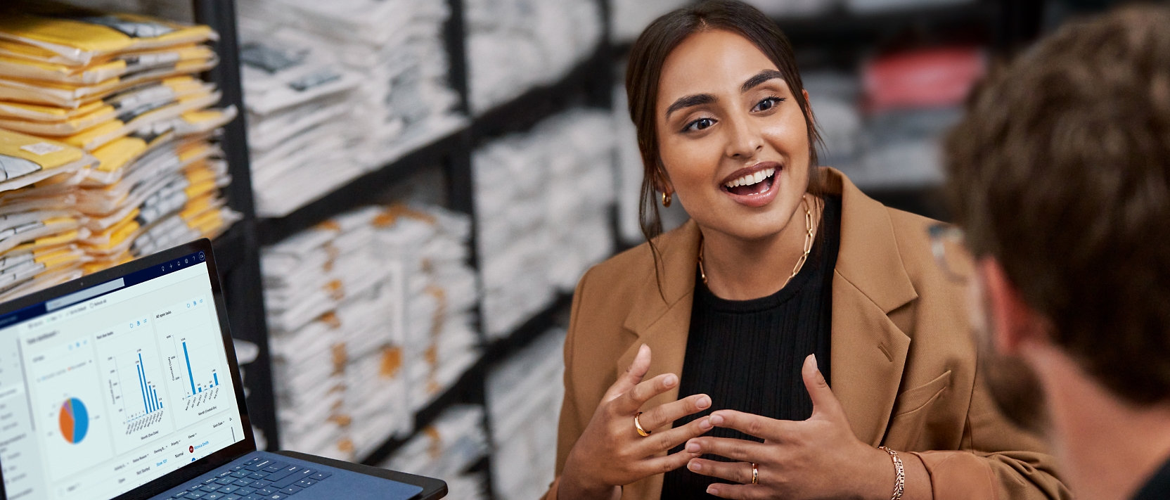 A woman is talking to a man in a warehouse.