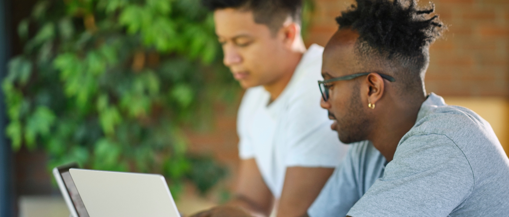 Two young men looking at a laptop.