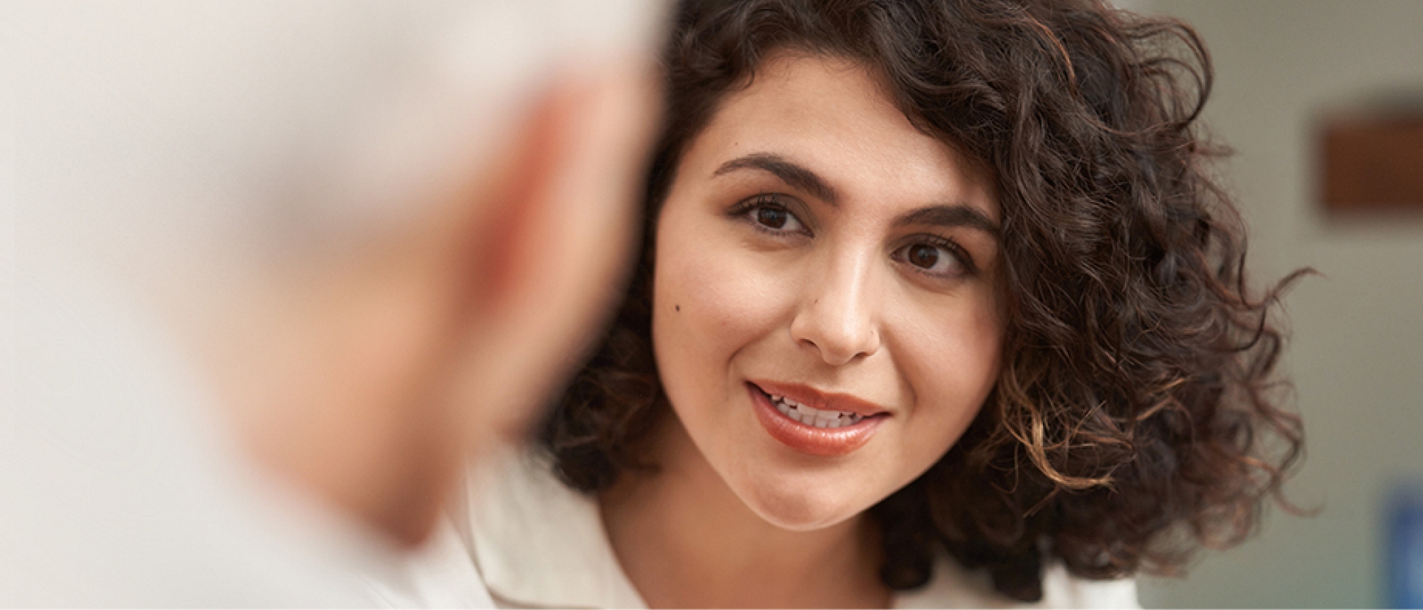 A woman is talking to an older man in an office.