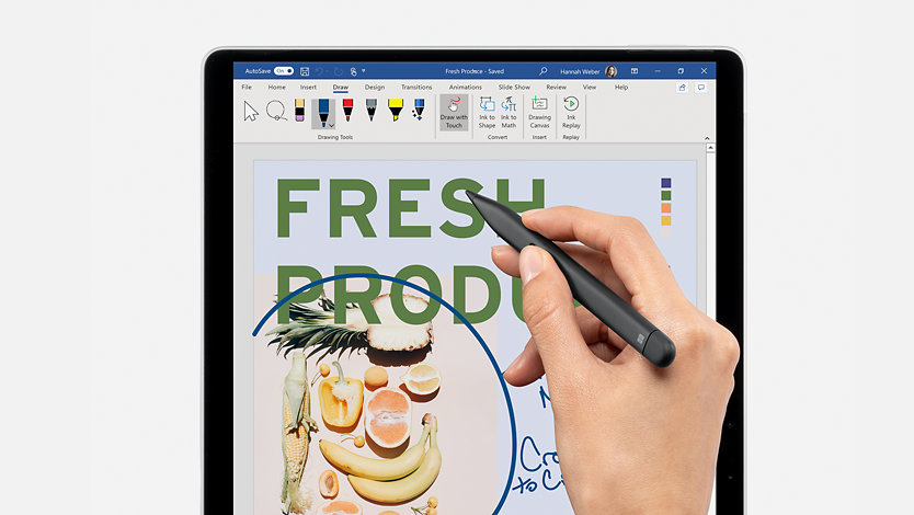 A hand designing with a Slim Pen on a Surface in tablet mode.