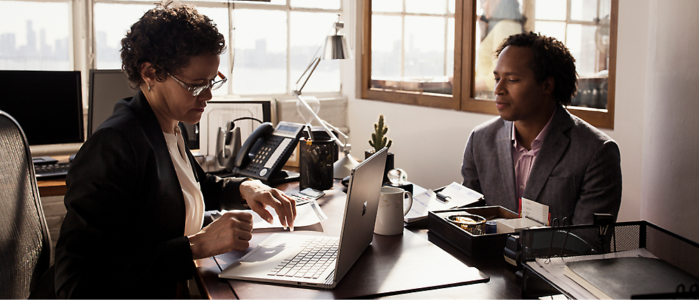 Two persons looking at a computer