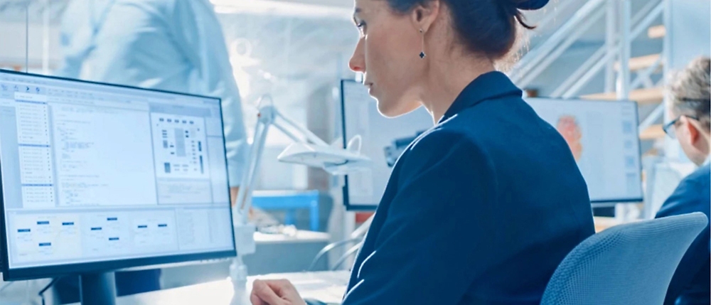 A woman looking at a computer screen.