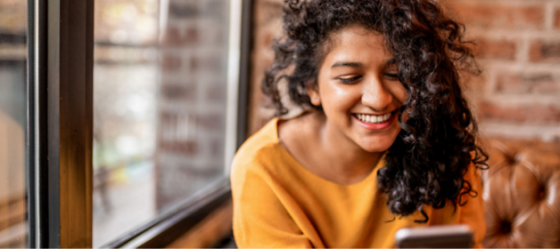 A girl smiling with curly hair