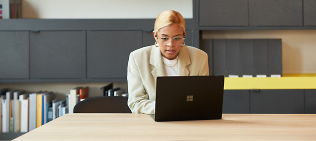 A person sitting at a desk using a computer