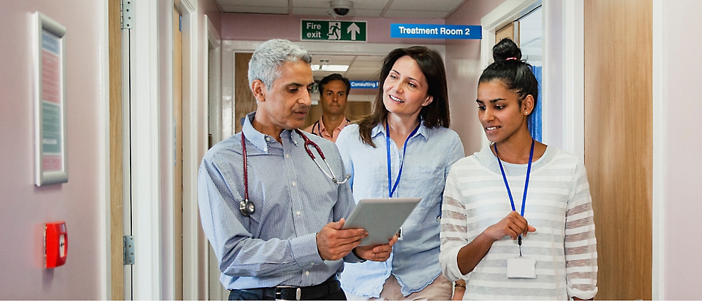 A group of people looking at a tablet