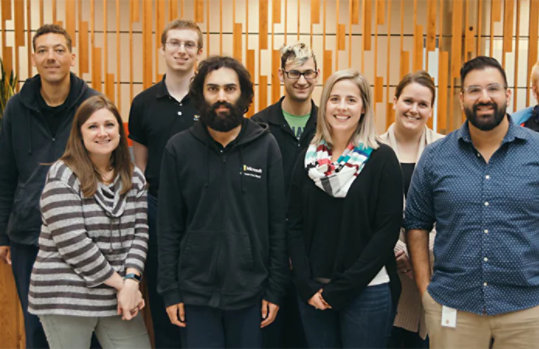 A small group of diverse people in the Supported Employment Program at Microsoft, smiling.