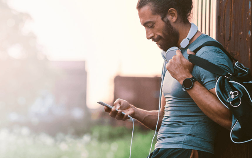 Man leaning on a wall and using SwiftKey Keyboard