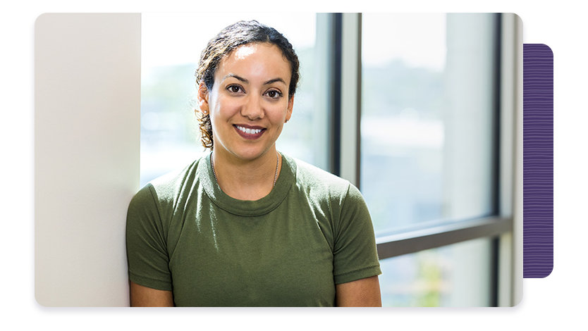 Person smiling in front of large window