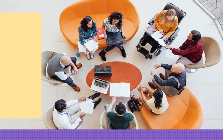 A casual meeting around a table viewed from above 