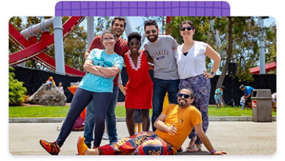 Group of six employees, posing for a picture outside