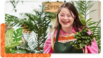 Florist in an apron surrounded by a room of plants