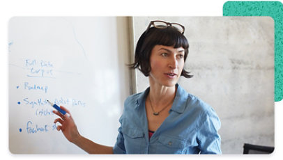 A person standing in front of a whiteboard and holding a marker