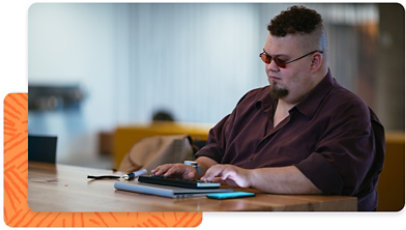 A person using a braille display in an office environment