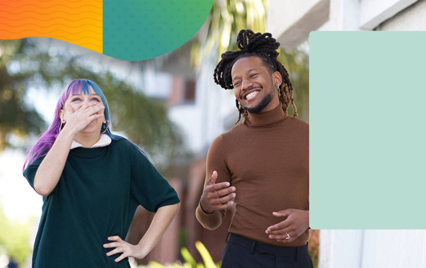 Two people standing outside and laughing together