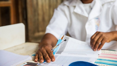 A medical worker goes through paperwork, including height measurement graphs, as part of a nutrition enhancement program in Madagascar.