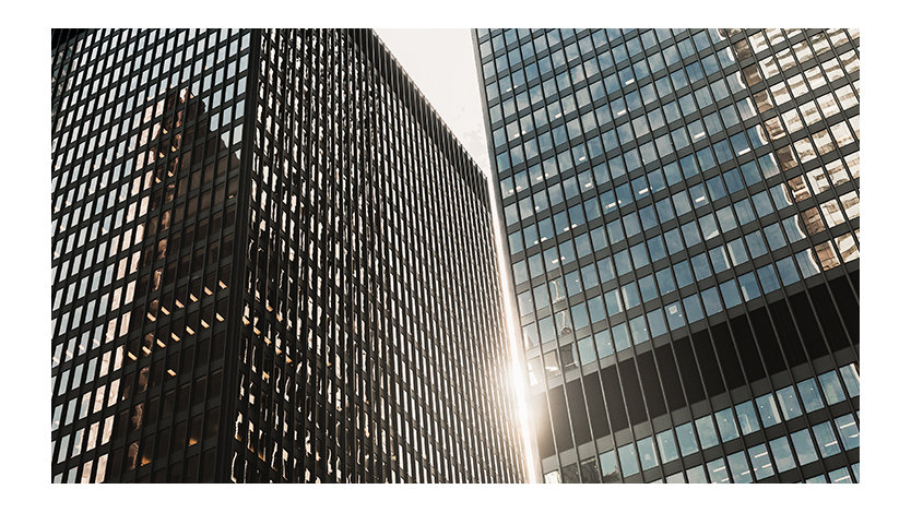 Exterior view of two skyscraper towers in a city setting.