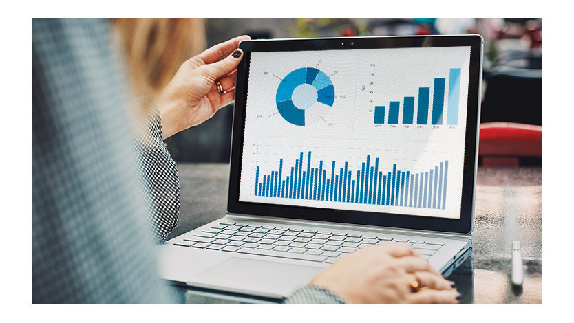 Mobile professional using a Surface Book and Surface Pen viewing a financial chart.