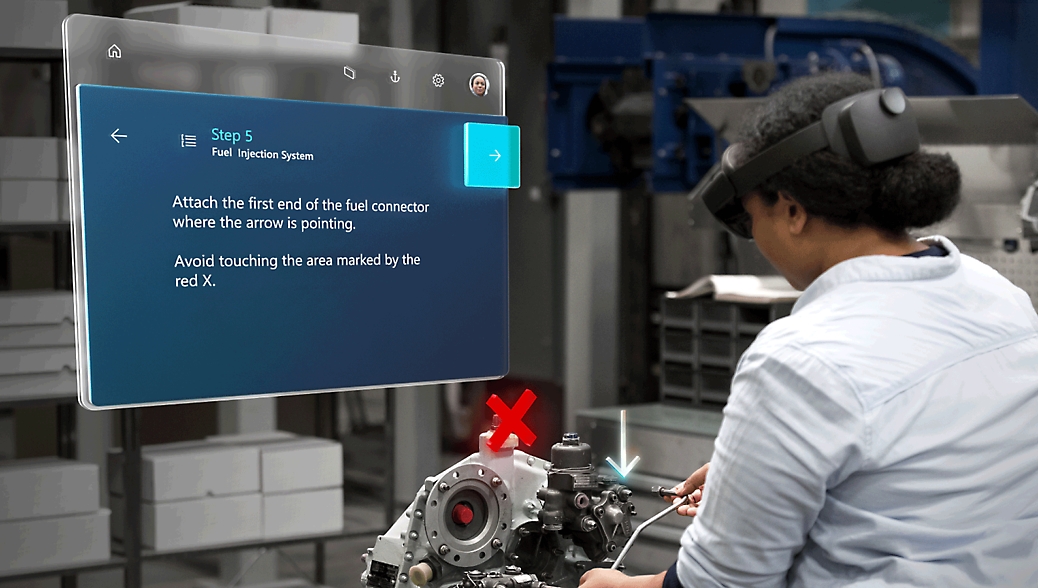 A technician in a factory follows instructions on a digital display while assembling a fuel injection system marked with a red "x.