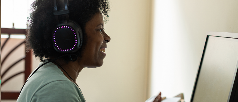 Woman with headphones working on a computer.