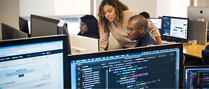 A group of people working on computers in an office