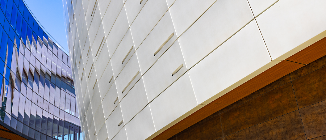 Exterior view showing the juxtaposition of two modern buildings with sleek, angular designs and different facade materials.