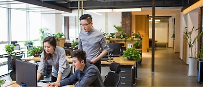 Two men and a women working in a office