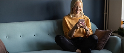 A women having mobile in hand with smiling face