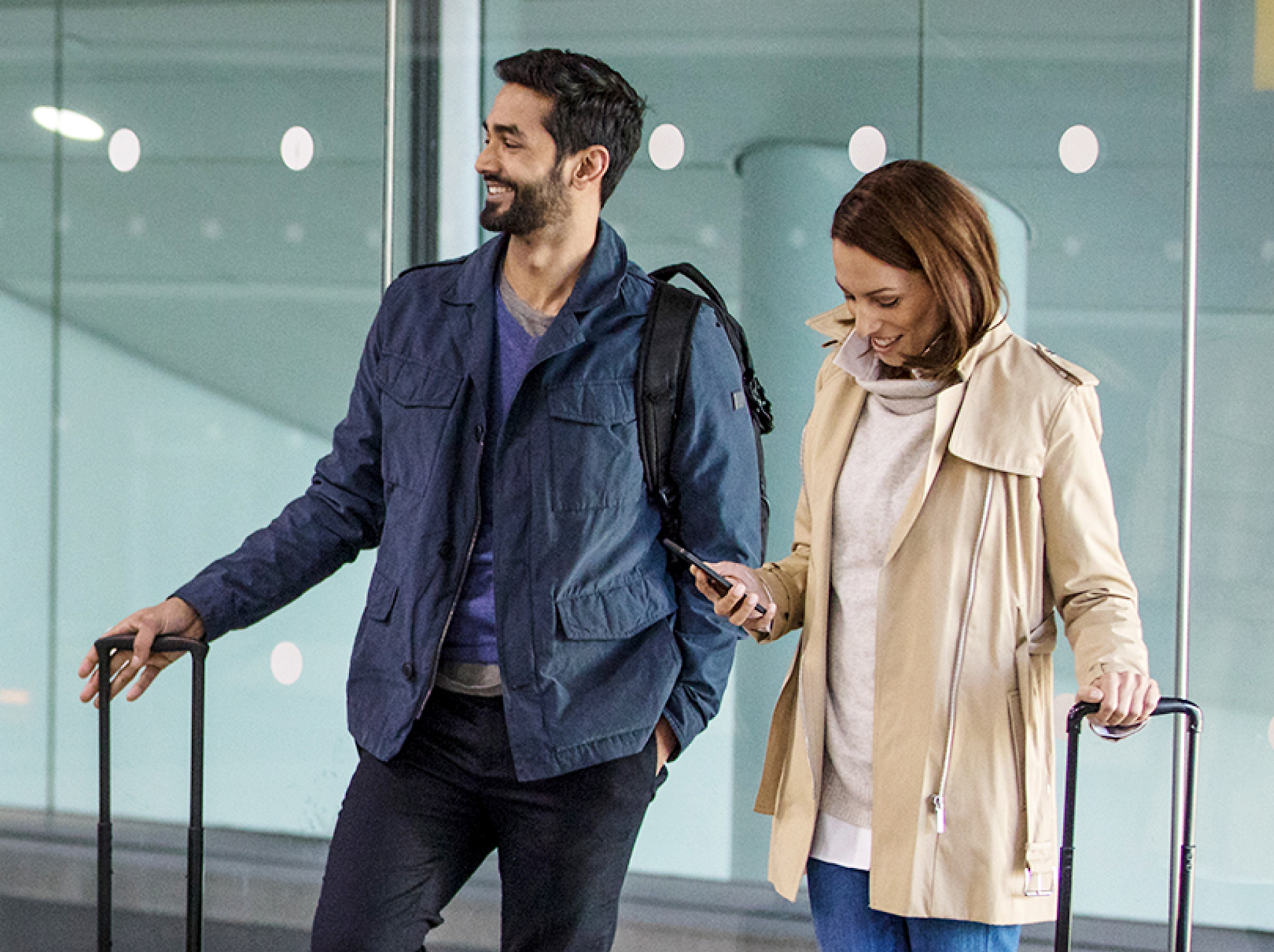 Two persons standing with luggage