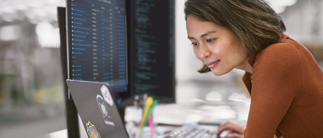 A woman is looking at a computer screen.