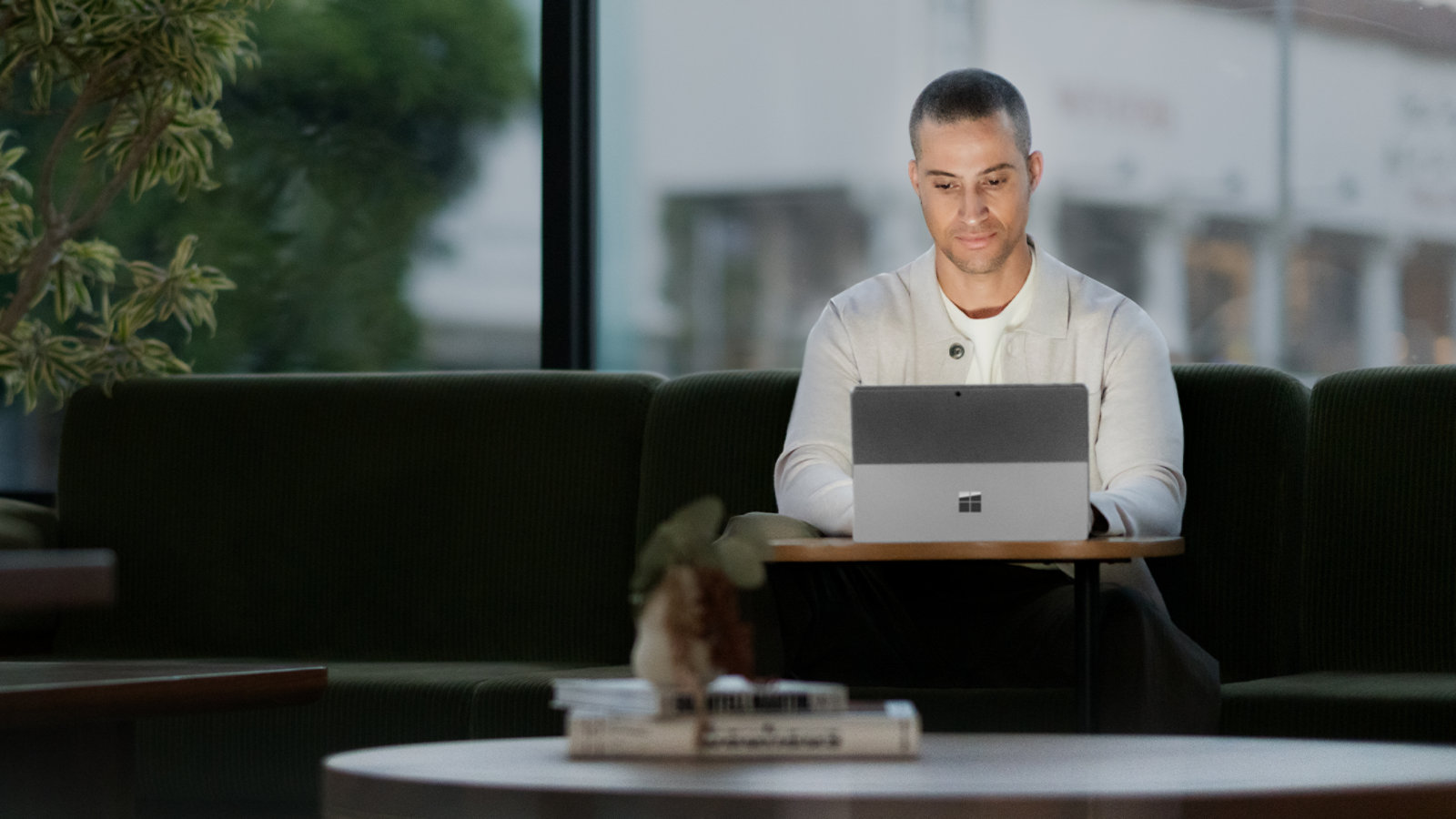 A person uses Surface Pro 10 for Business in a public space.