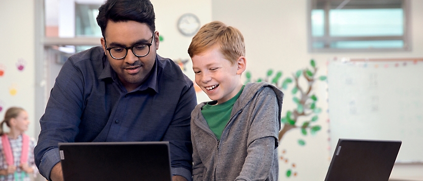 A person and child looking at a computer